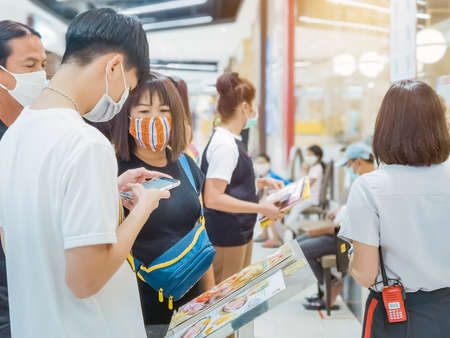 Kanchanaburi, Thailand - June 21,2020: unidentified cashier and customers wear protective masks to protect against coronavirus (Covid-2019) and shopping at the Robinson Department Store.のeditorial素材