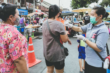 Kanchanaburi, Thailand - June 21,2020: unidentified cashier and customers wear protective masks to protect against coronavirus (Covid-2019) and shopping at the Robinson Department Store.のeditorial素材
