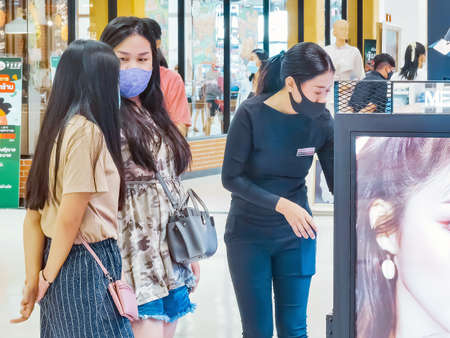 KANCHANABURI,THAILAND-JUNE 28,2020:Examination of body temperature and register identity using QR...