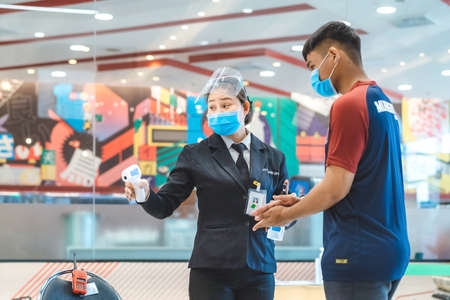 Kanchanaburi,Thailand-JULY 2,2020:Thai students wear various medical masks to prevent themselves from Coronavirus(Covid-19)in time after school and going back home after rain stopped at KTR school.のeditorial素材