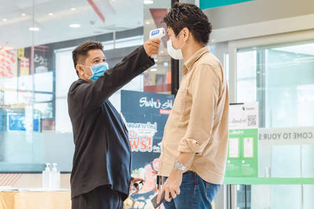 Kanchanaburi,Thailand-JULY 2,2020:Thai students wear various medical masks to prevent themselves from Coronavirus(Covid-19)in time after school and going back home after rain stopped at KTR school.のeditorial素材