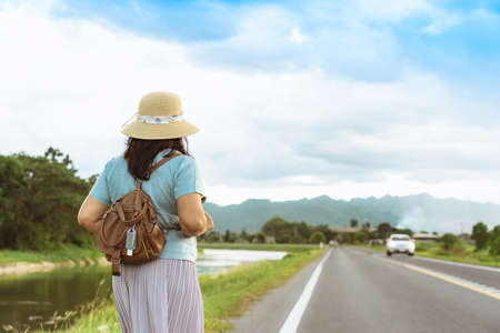 Mini portable alcohol gel bottle to kill Corona Virus(Covid-19) hang on a leather shoulder bag of a woman go to shopping at the mall. New normal lifestyle. Selective focus on alcohol gelの写真素材