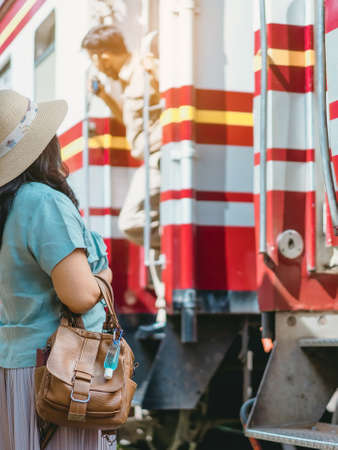 Mini portable alcohol gel bottle to kill Corona Virus(Covid-19) hang on a leather shoulder bag of a woman go to shopping at the mall. New normal lifestyle. Selective focus on alcohol gelの写真素材