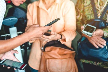 Mini alcohol gel bottle to kill Corona Virus(Covid-19) hang on a brown leather shoulder bag with hot coffee on table in cafe.New normal lifestyle.Health care concept.Selective focus on alcohol gelの写真素材