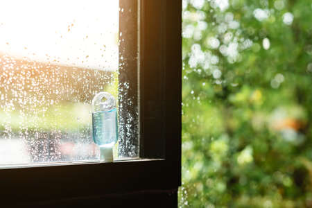 Blue alcohol gel bottle for hand cleaning to prevent the spreading of the Coronavirus (Covid-19), Placed on table to service for customers in the cafe. Healthcare concept. New normal lifestyleの写真素材