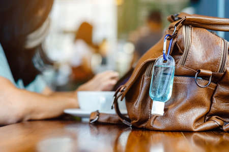 Blue alcohol gel bottle for hand cleaning to prevent the spreading of the Coronavirus (Covid-19), Placed on table to service for customers in the cafe. Healthcare concept. New normal lifestyleの写真素材