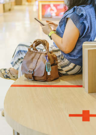 Blue alcohol gel bottle and a register book on the table for athletes to prevent Corona Virus (COVID -19) infection and spread before exercising in public park. New normal lifestyle. Selective focusの写真素材