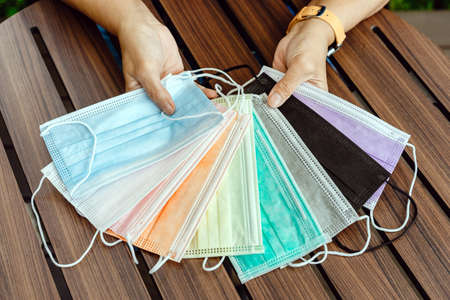Mini alcohol gel bottle to kill Corona Virus(Covid-19) hang on a leather shoulder bag of a woman...
