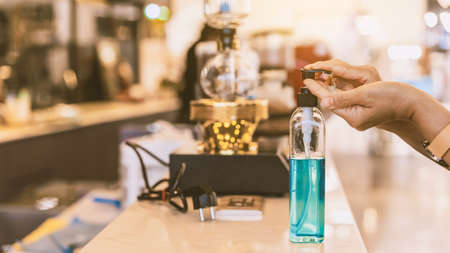 Quarantined woman wear protective sterile medical mask with a cold drink while using smartphone.Concepts of Flu virus,Covid-19 (Coronavirus disease).New normal lifestyle.Selective focus.の写真素材