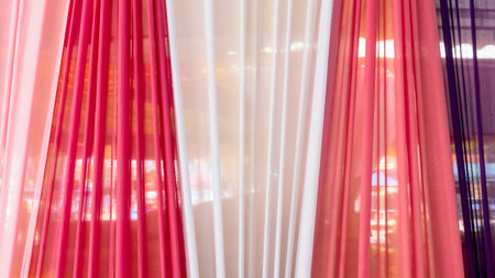 Beautiful multi-colored curtains decorated as a backdrop for the Buddhist ceremonies in Southeast Asia. Fabric colour and texture swatches. Background of colorful curtains hangs seamlessly together.の写真素材