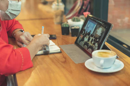 Close up to barista make coffee with Vacuum Pot Syphon Brewer.  Syphon (Siphon) coffee maker brews drink using two chambers where vapor pressure and vacuum produce coffee in cafe. Selective focus.の写真素材