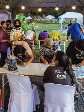 KANCHANABURI,THAILAND-SEPTEMBER 12, 2020:Examination of body temperature and register identity using QR code or registration book before entry to prevent Coronavirus(Covid-19) pandemic at Local marketのeditorial素材