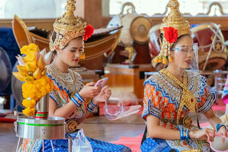NAKHONPATHOM ,THAILAND-FEBRUARY 14,2021:Traditional Thai dance with protective face shield to...