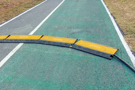 Black and yellow heavy plastic covers for people and vehicle to cross over cables laid on road....