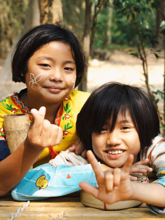 RATCHABURI THAILAND-JANUARY 19,2020 : Unidentified Karen young girls smile happily and extends her...