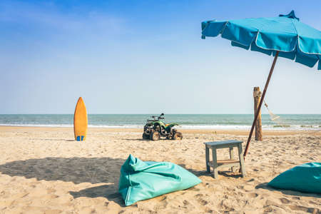 Vintage green ATV on the sandy beach. Quad ATV all terrain vehicle parked on beach, Motor bikes ready for action with summer sun flaring on bright day. Outdoor extreme activity adrenaline sport.の写真素材