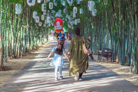 KANCHANABURI, THAILAND-DECEMBER 22,2020 : Back view of Unidentified Asian family walking to relax...