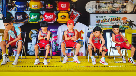 KANCHANABURI,THAILAND-NOVEMBER 14,2020 : Figurine dolls or statue of serious substitute basketball team sit on chairs for sale as street souvenir at Robinson Department Store. Game and Sport concept.のeditorial素材