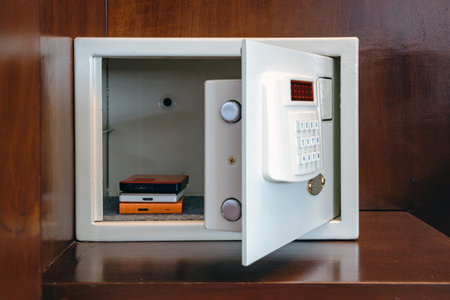 Security external hard drive in open metal safe. External hard disk containing confidential and important information keep well in white safe box. Confidentiality and Importance of Information Conceptの写真素材