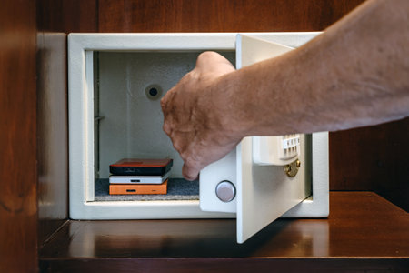 Security external hard drive in open metal safe. External hard disk containing confidential and important information keep well in white safe box. Confidentiality and Importance of Information Conceptの写真素材