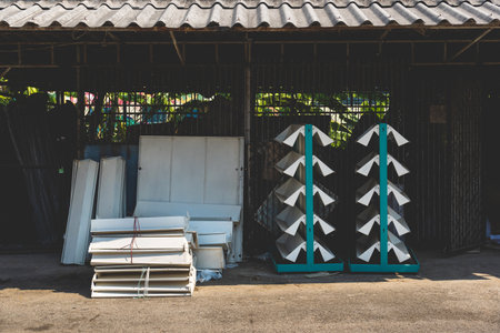 Empty old metal book or magazines shelves. Old bookshelves that are no longer in use due to the end of the new generations reading era have been abandoned and no longer matter in front of the old shedの写真素材