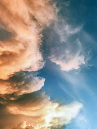 Clouds in the blue sky. Natural sky background texture, beautiful color. Peaceful blue sky with light clouds. The free form beauty of clouds and sky is perfect for background, backdrop and wallpaper.の写真素材