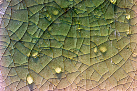 Close up to background and texture of stretch marks cracked on emerald green glazed tile. Scratches background. Vintage scratched grunge tile broken screen texture. Scratched glass surface wallpaper.の写真素材