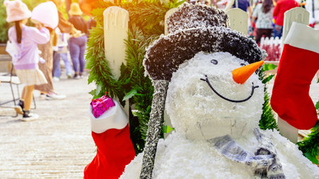 Beautiful decorative artificial snowman decoration at the entrance to a small housing community. Snowman standing in front of the public park on the Christmas holiday. Christmas and New Year Concept.の写真素材