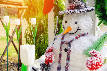 Beautiful decorative artificial snowman decoration at the entrance to a small housing community. Snowman standing in front of the public park on the Christmas holiday. Christmas and New Year Concept.の写真素材