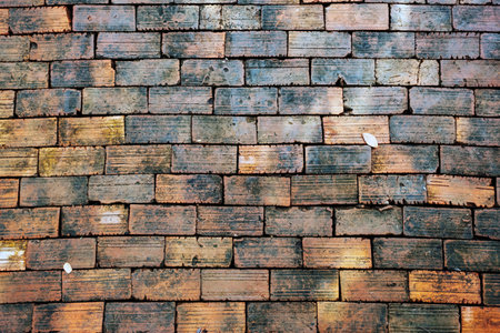 Top view of old bricks paving stones footpath pattern on sidewalk outdoors as brickwork weave texture or abstract stone paver background. Top view of pavement surface. Bricks Background and texture.の写真素材