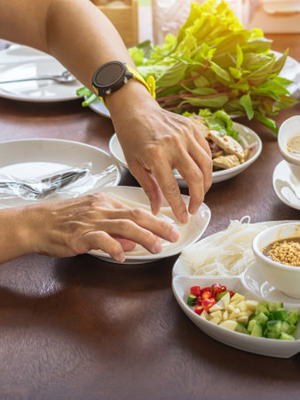 Enjoy eat with Vietnamese Meatball Wraps (Nam-Neung), Pork Sausage wraps with fresh vegetables in rice paper, generous platter eat with sweet sauce. Vietnamese Pork Sausage and salad. Selective focus.の写真素材