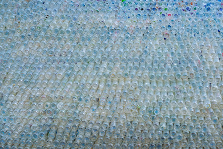 Beautiful wall made of recycled transparent plastic bottles.Bottle recycling of plastic bottles...