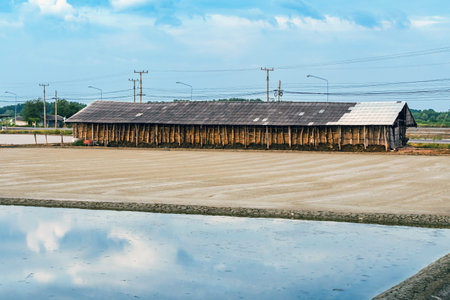 Salt storage granaries, sea salt storage in salt farms. Granary for salt storage and salt farm Solar. Abandoned old wood salt barn storage. Traditional wooden barn for storing salt beside salt pan.の写真素材