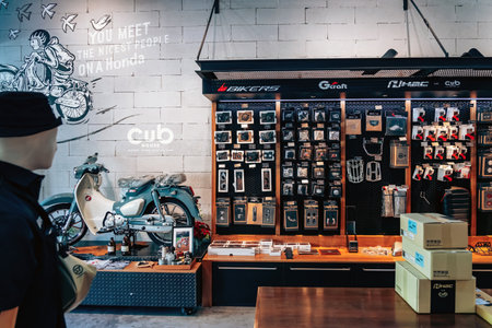 NAKHON PATHOM,THAILAND-JANUARY 7, 2023 : Motorcycling accessories and spare parts of Honda Cub Motorcycle classic collection on display for sale at CUB House Nakhon Pathom Honda x Greyhound Coffee.のeditorial素材