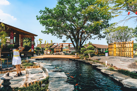 KANCHANABURI -THAILAND, MARCH 30 ,2023 : Unidentified Tourists come to visit and take photo with restaurant and cafe with a beautiful garden decorated in Japanese style at Tomi Edoのeditorial素材
