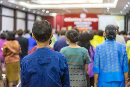 Back view of senior man wear face mask attending and listening to the annual meeting in the auditorium. Asian elderly active participants in conference room. Joyful listeners of business conference.の写真素材