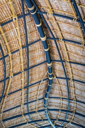 Beautiful thatched roof surface detail of mixed materials pattern structure by weave pile straw with steel bars. 
Roofâ madeâ ofâ straw. Pattern of under bamboo roof frame.
Wooden thatched ceiling.の写真素材
