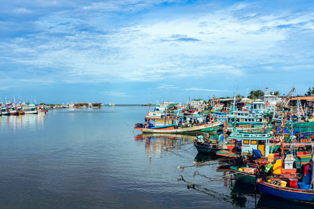 PHETCHABURI-THAILAND, AUGUST 20, 2022 : Beautiful scenic of variety colorful fishing boats at pier with seaview in evening at Phoo Chuk Bridge,Cha-Am. Commercial fishing vessels docked at fish villageのeditorial素材