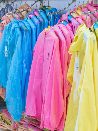 DA NANG CITY-VIETNAM, OCTOBER 14, 2023 : Variety of beautiful colorful sport jackets made from bamboo pulp for good health hanging for sale in shopping mall or department store. Multicolored fabrics.のeditorial素材