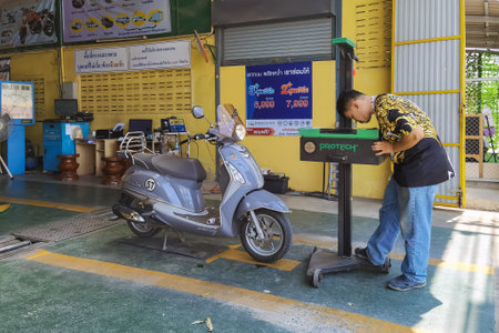 KANCHANABURI, THAILAND-MAY 23,2023 : Motorcycle inspection to vehicle inspection certificate for annual vehicle tax payment at Vehicle inspection facility. Checks condition of motorcycle in workshop.のeditorial素材