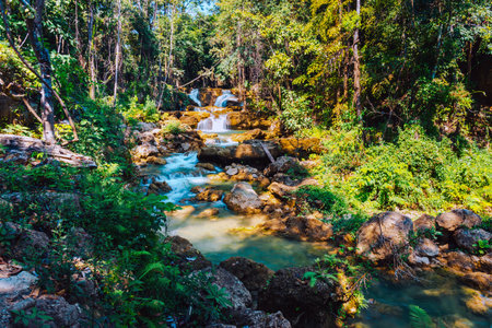 Beautiful of Huai mae khamin waterfall Srinakarin national park at Kanchanaburi thailand. Waterfall clear emerald water on autumn and summer season with rock for holiday relax on green tree in jungle.の写真素材