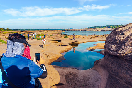 UBON RATCHATHANI, THAILAND-DECEMBER 9,2023 : Unidentified tourists enjoy sightseeing at Sam Phan Bok near Mekong River is called Valley of Thailand. Grand Canyon in Thailand. Beautiful landscape view.のeditorial素材