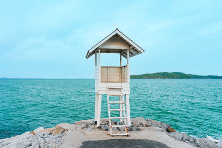 Beautiful view landscape summer small white wooden lighthouse with sea and island in background, Landmark and viewpoint at the Gulf of Thailand "Khao Leam Ya National Park". Perfect for vacation.の写真素材