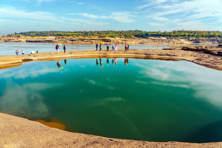 UBON RATCHATHANI, THAILAND-DECEMBER 9,2023 : Unidentified tourists enjoy sightseeing at Sam Phan Bok near Mekong River is called Valley of Thailand. Grand Canyon in Thailand. Beautiful landscape view.のeditorial素材
