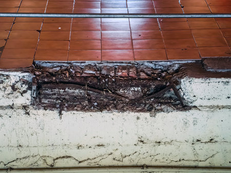 Old floor tiles around the edges cracked and loose. Dirty cracks around the edge of tile floor inside the building. Poor construction and floor tiles. Dirtiness in the area where the tiles were loose.の写真素材