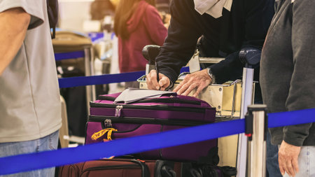Hand of man traveler using pen filling immigration form at airport. Male tourist hand filling...