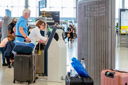BANGKOK-THAILAND, FEBRUARY 20,2023 : Unidentified passengers using automated self check-in or self service machine at Suvarnabhumi International Airport. Innovation at the service of people concept.のeditorial素材