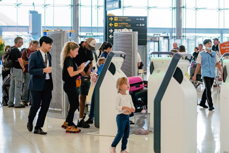 BANGKOK-THAILAND, FEBRUARY 20,2023 : Unidentified passengers using automated self check-in or self service machine at Suvarnabhumi International Airport. Innovation at the service of people concept.のeditorial素材