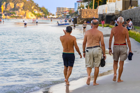Back view of senior friends enjoying the beach in the summertime. Cheerful group of friends or family enjoying summer holiday together.
Happy group of traveler senior people enjoying seaside holidays.の写真素材