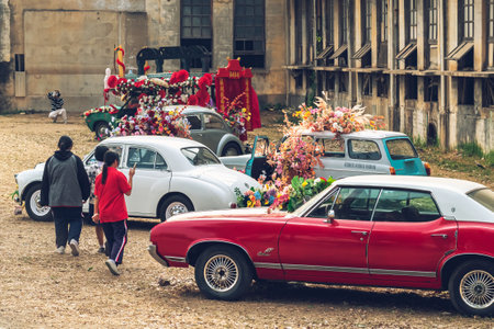 KANCHANABURI,THAILAND-FEBRUARY 12,2024 : An exhibition of beautiful antique cars decorated with artificial flower bouquets on lawn at The old paper mill. Vintage car with beautiful flower bouquet.のeditorial素材